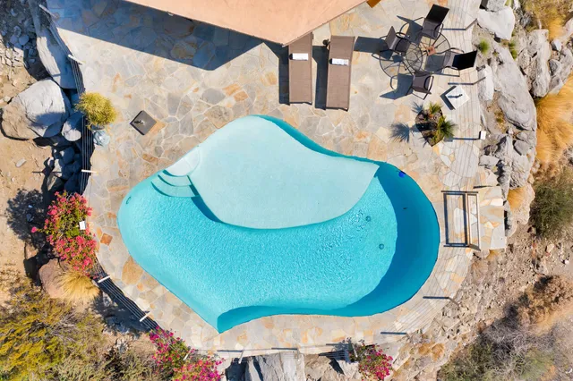 a view of a swimming pool with lake view and mountain view