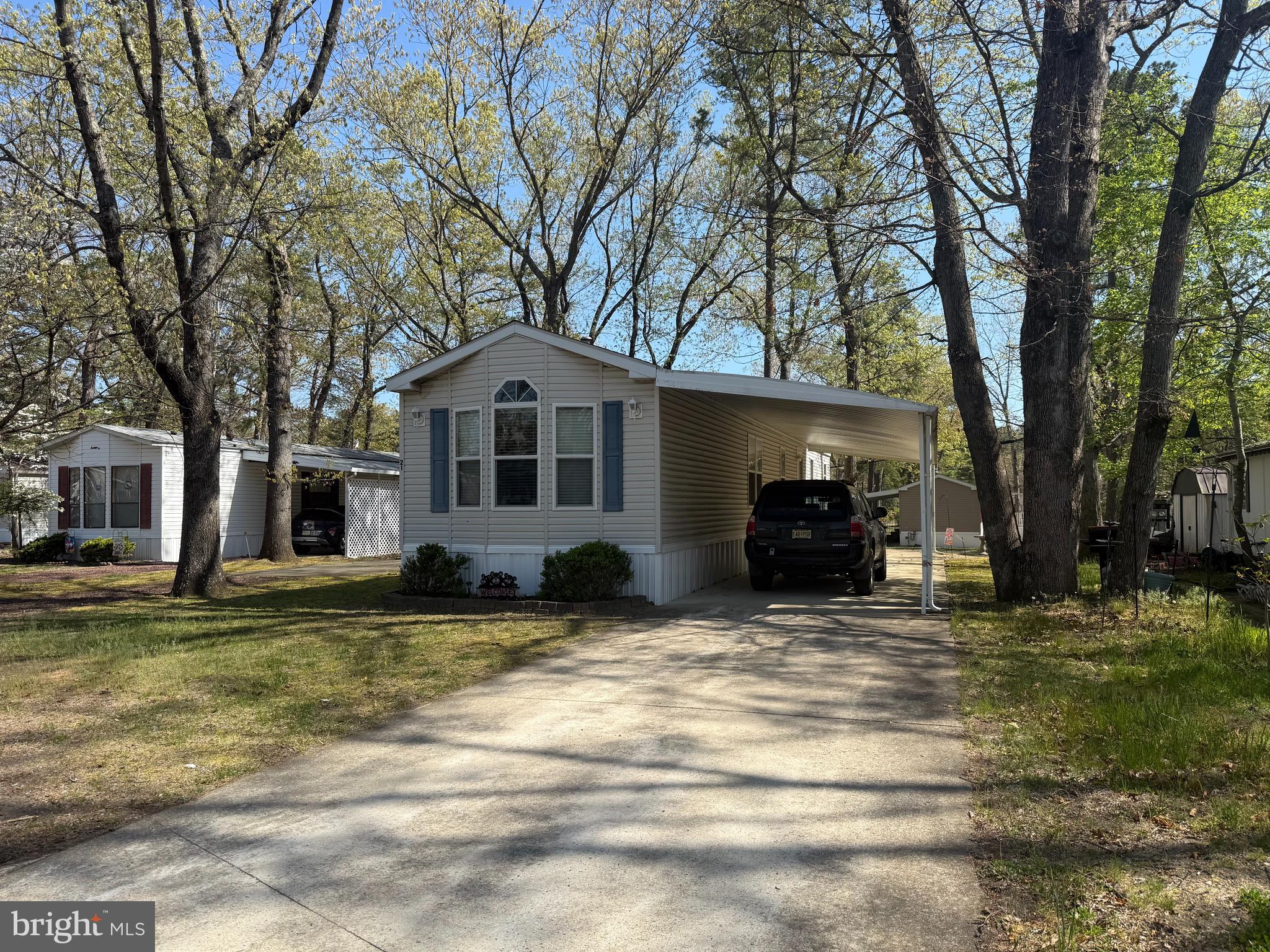a view of a house with a large tree in front of a house