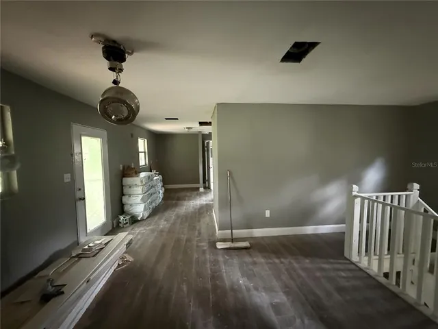 a view of a room with wooden floor