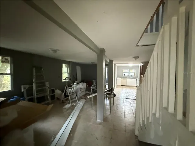 a lobby with furniture and floor to ceiling window