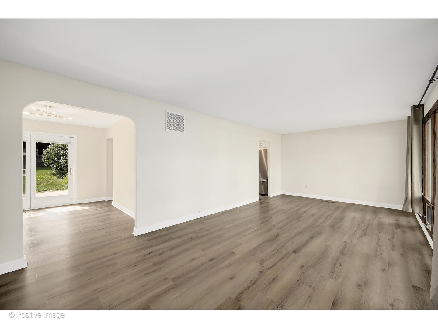 1120 Grant Street Wheaton, IL 60189 - Photo 3 of 17 a view of an empty room with wooden floor and a window
