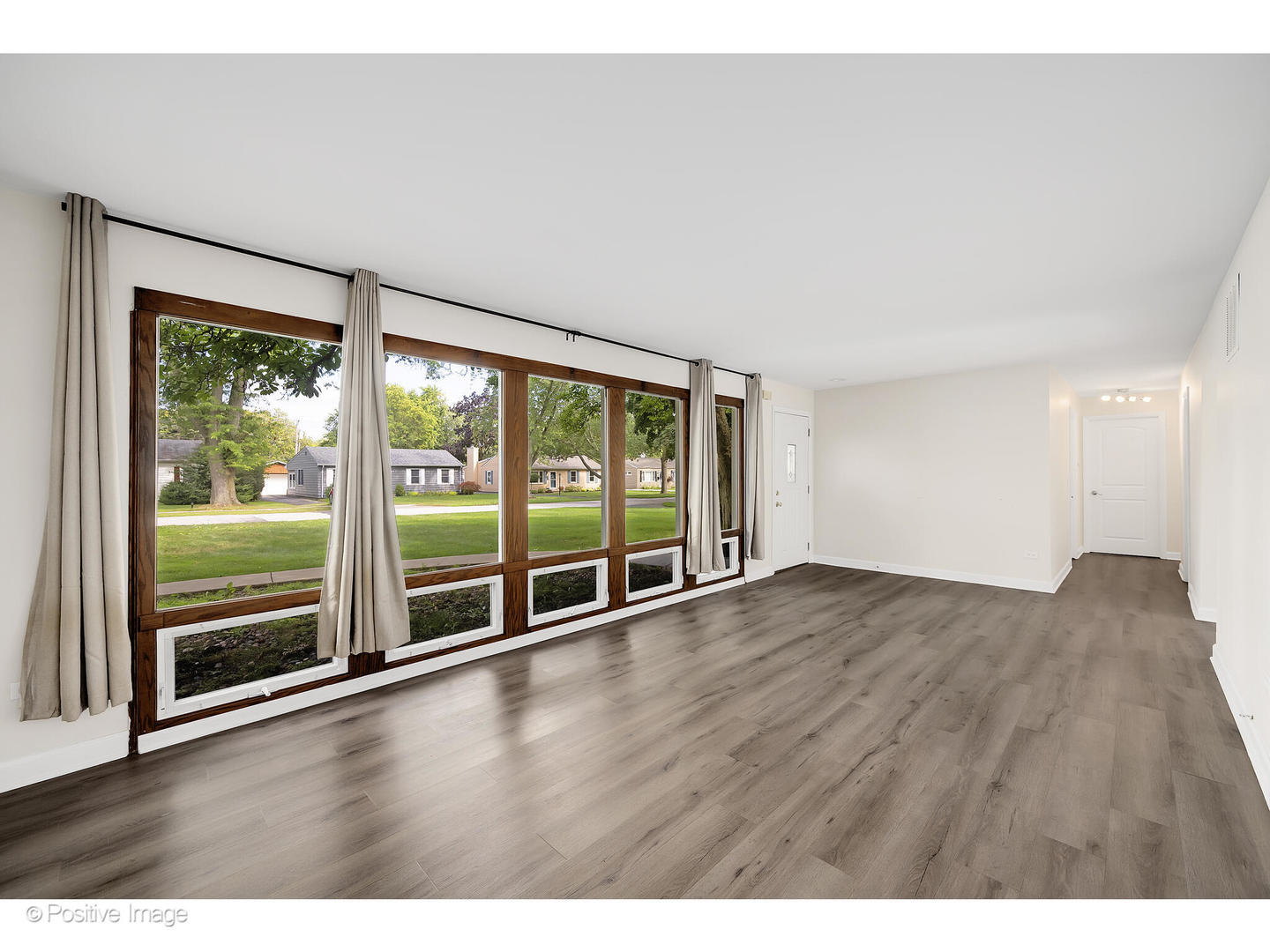 1120 Grant Street Wheaton, IL 60189 - Photo 4 of 17 a view of an empty room with wooden floor and a window