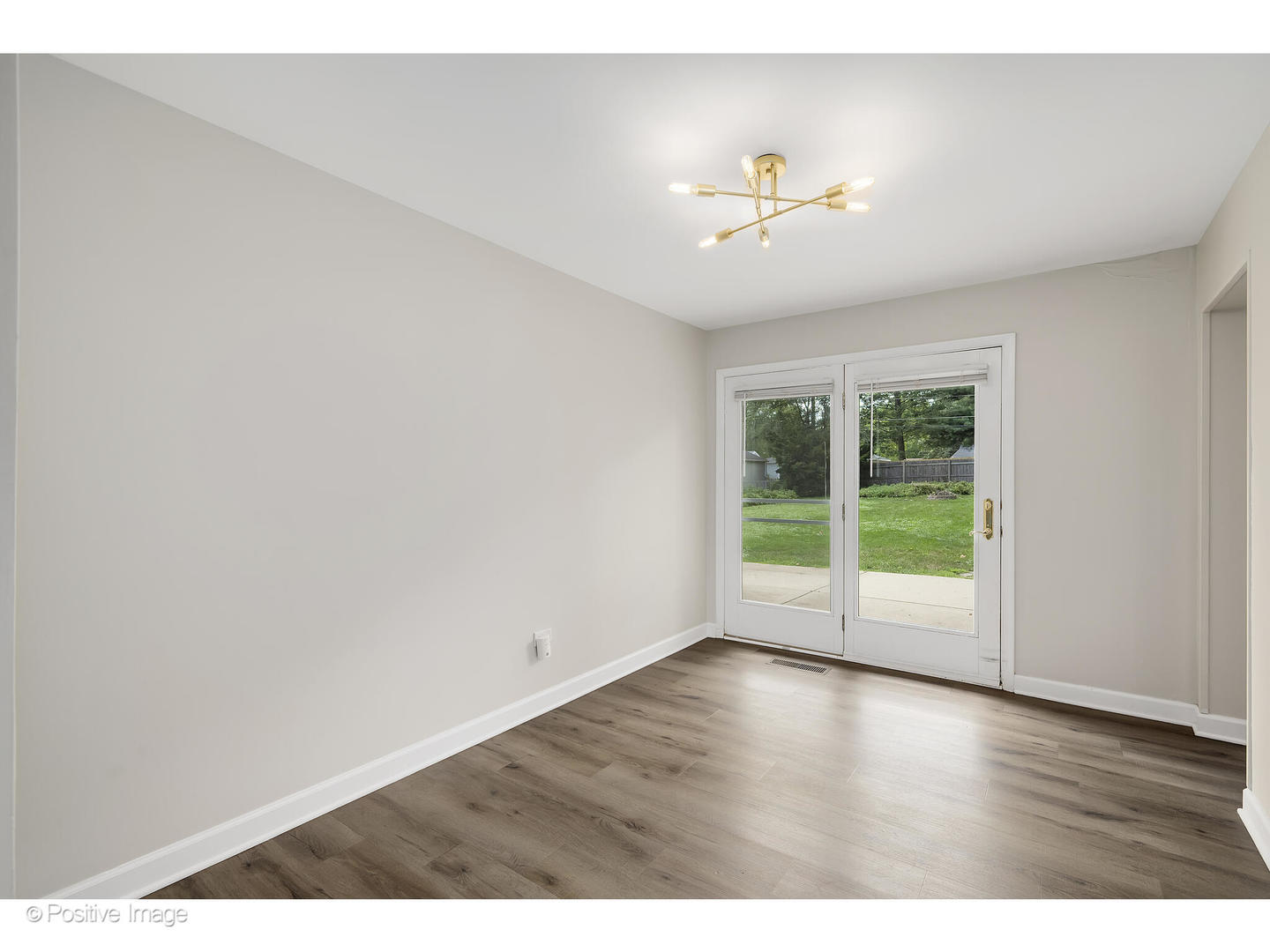 1120 Grant Street Wheaton, IL 60189 - Photo 5 of 17 a view of an empty room with wooden floor and a window