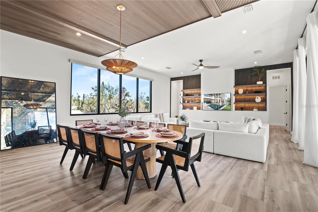 7007 Point Of Rocks Road Sarasota, FL 34242 - Photo 17 of 62 a dining room with furniture a chandelier and wooden floor