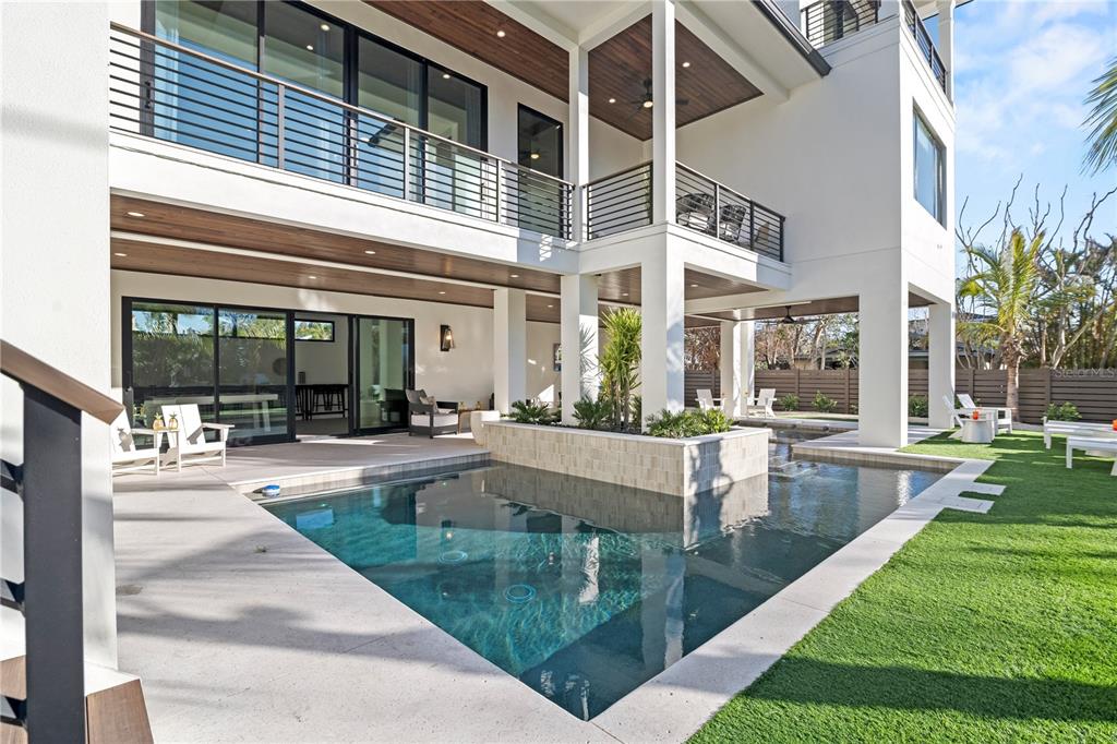 7007 Point Of Rocks Road Sarasota, FL 34242 - Photo 2 of 62 a view of a swimming pool with a bench in patio