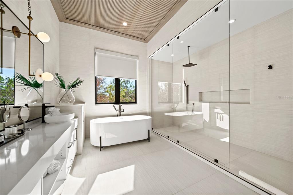 7007 Point Of Rocks Road Sarasota, FL 34242 - Photo 23 of 62 a bathroom with a tub sink and mirror