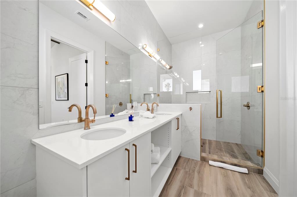 7007 Point Of Rocks Road Sarasota, FL 34242 - Photo 34 of 62 a bathroom with a sink a toilet a mirror and shower