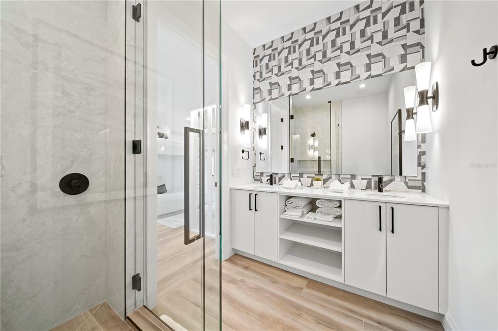 7007 Point Of Rocks Road Sarasota, FL 34242 - Photo 40 of 62 a bathroom with a double vanity sink mirror and shower