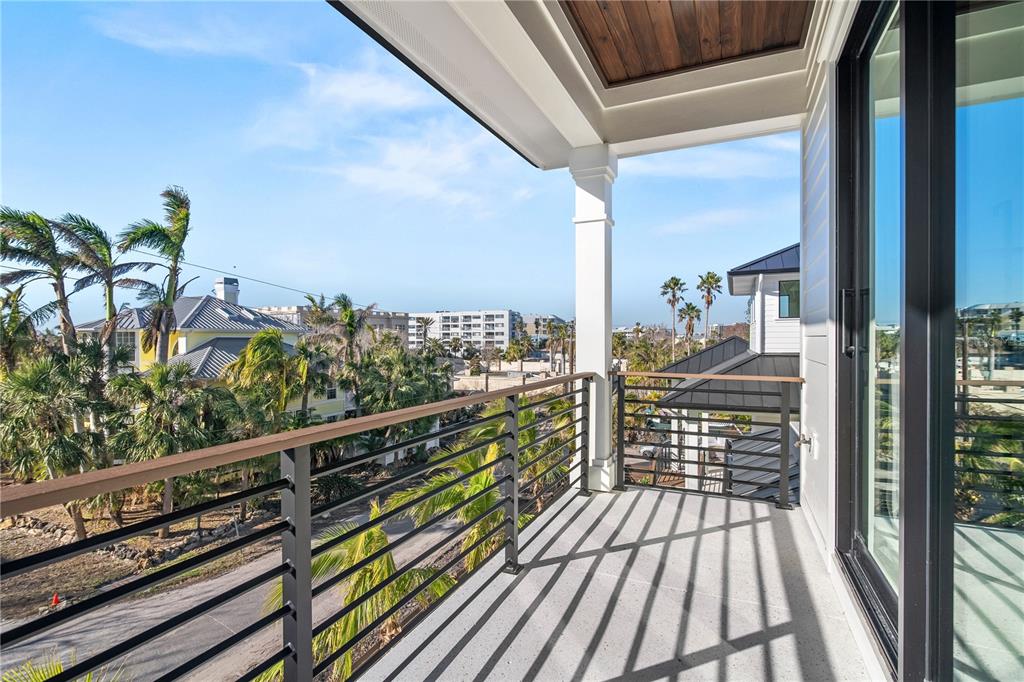 7007 Point Of Rocks Road Sarasota, FL 34242 - Photo 48 of 62 a balcony with wooden floor table and chairs