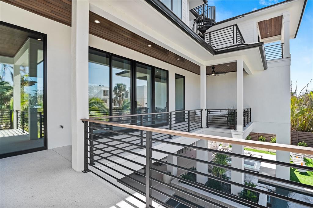 7007 Point Of Rocks Road Sarasota, FL 34242 - Photo 60 of 62 a view of a room with wooden floor and iron stairs
