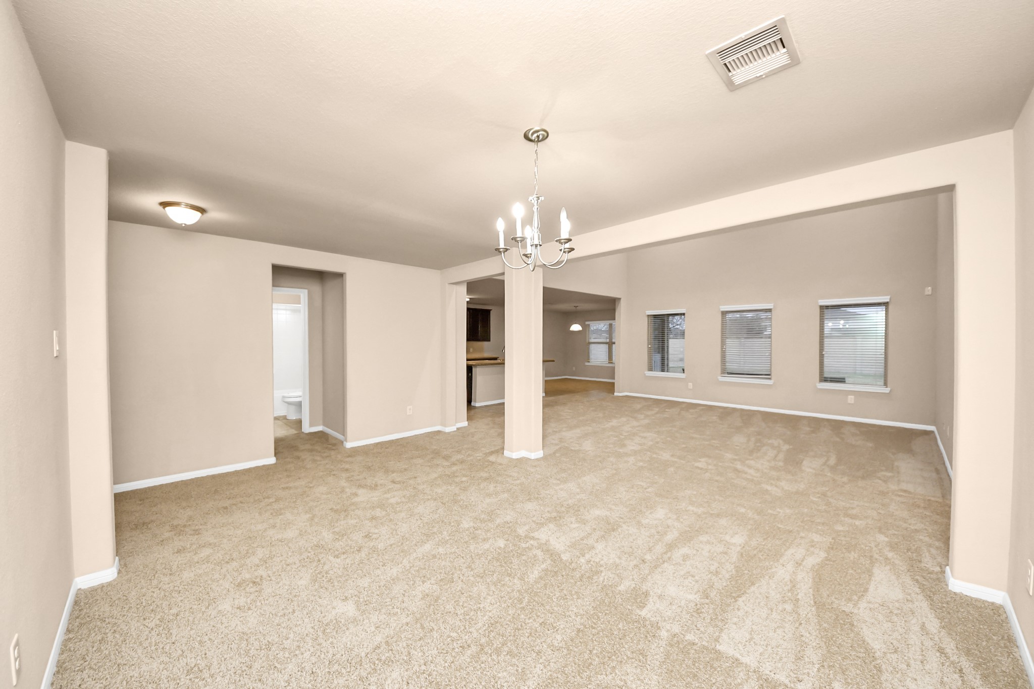 9326 Limestone Ranch Lane Richmond, TX 77407 - Photo 22 of 50 an empty room with chandelier fan and windows
