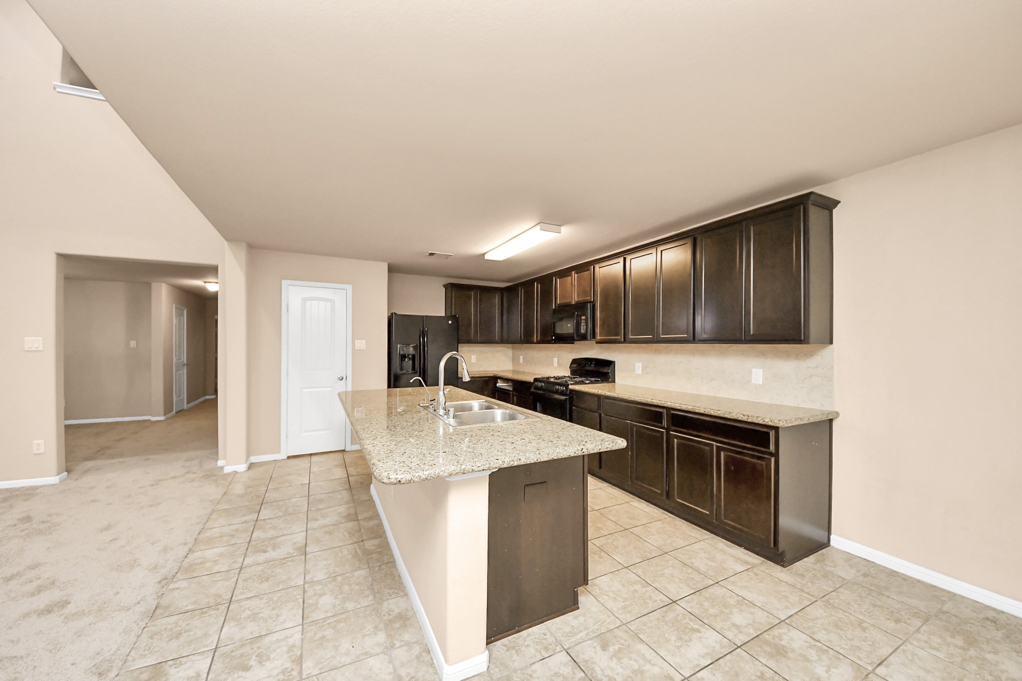 9326 Limestone Ranch Lane Richmond, TX 77407 - Photo 31 of 50 a kitchen with stainless steel appliances granite countertop a sink and a stove