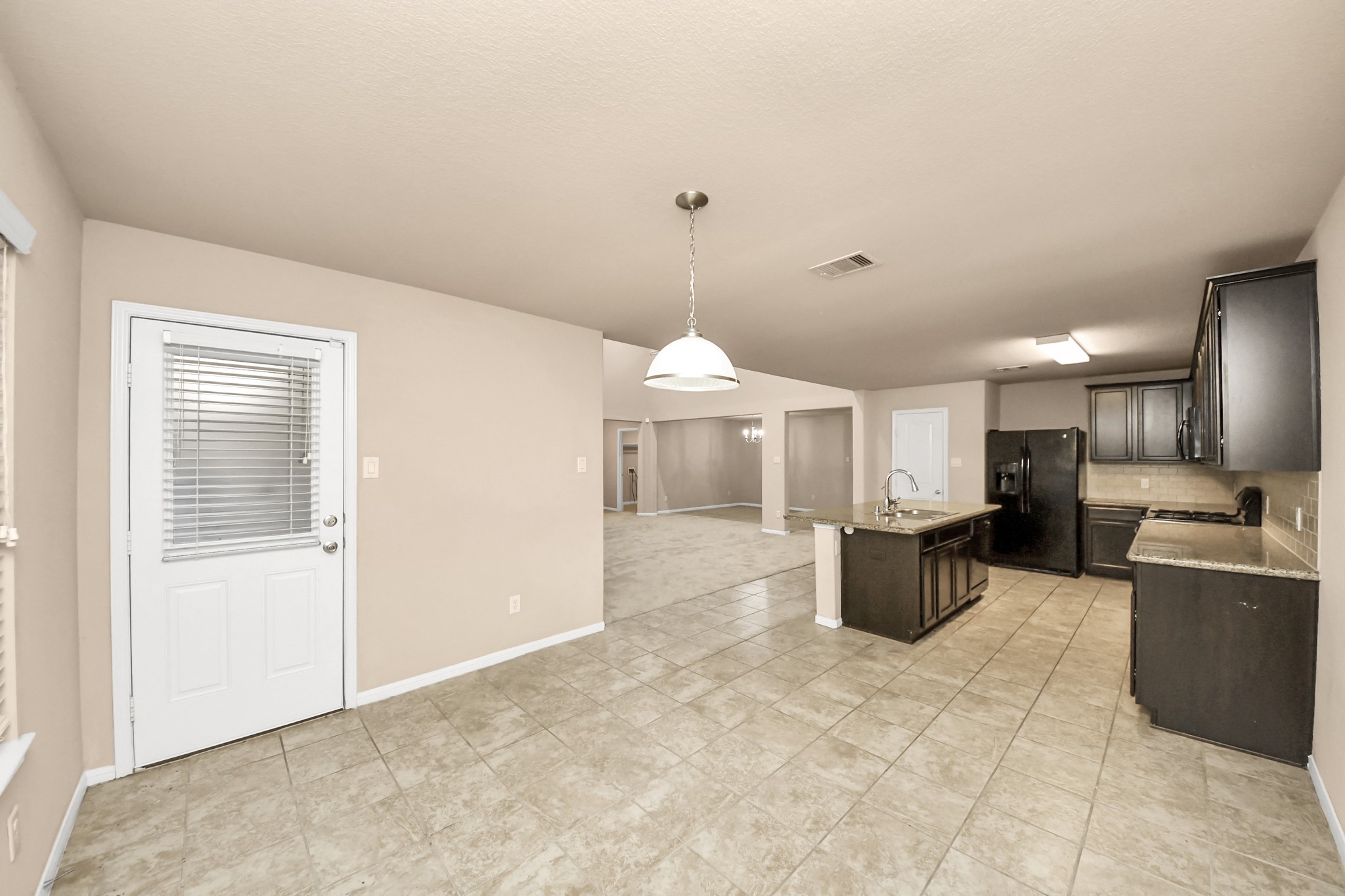 9326 Limestone Ranch Lane Richmond, TX 77407 - Photo 38 of 50 a living room with furniture a window and kitchen view