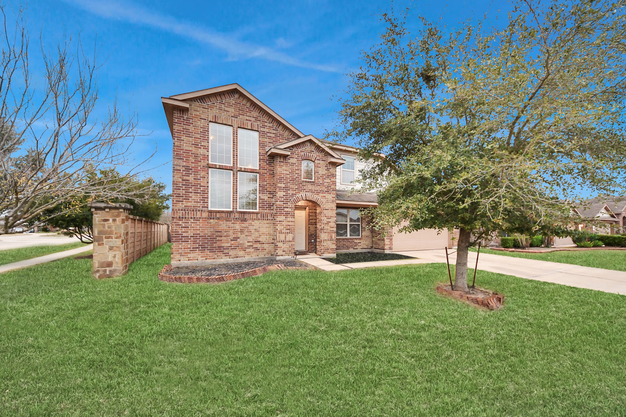 9326 Limestone Ranch Lane Richmond, TX 77407 - Photo 5 of 50 a front view of a house with a yard and a tree