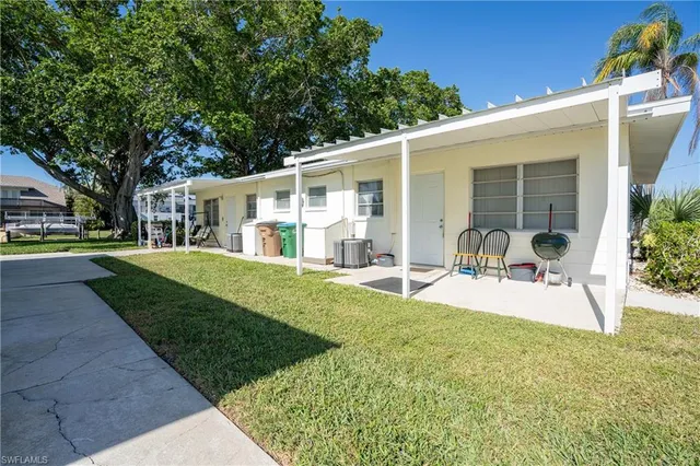 a view of a house with backyard porch and sitting area