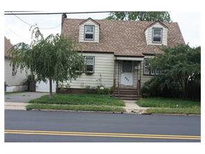 407 Florida Grove Road Perth Amboy, NJ 08861 - Photo 9 of 9 a front view of a house with a garden and trees