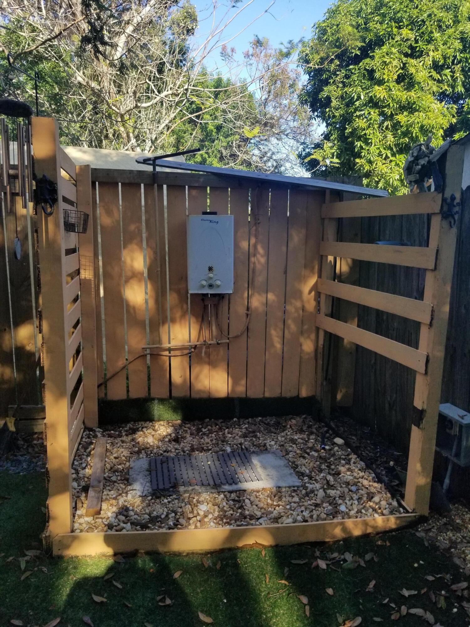 1224 Raymond Avenue Fort Pierce, FL 34950 - Photo 26 of 27 a view of a small house covered with trees in the background