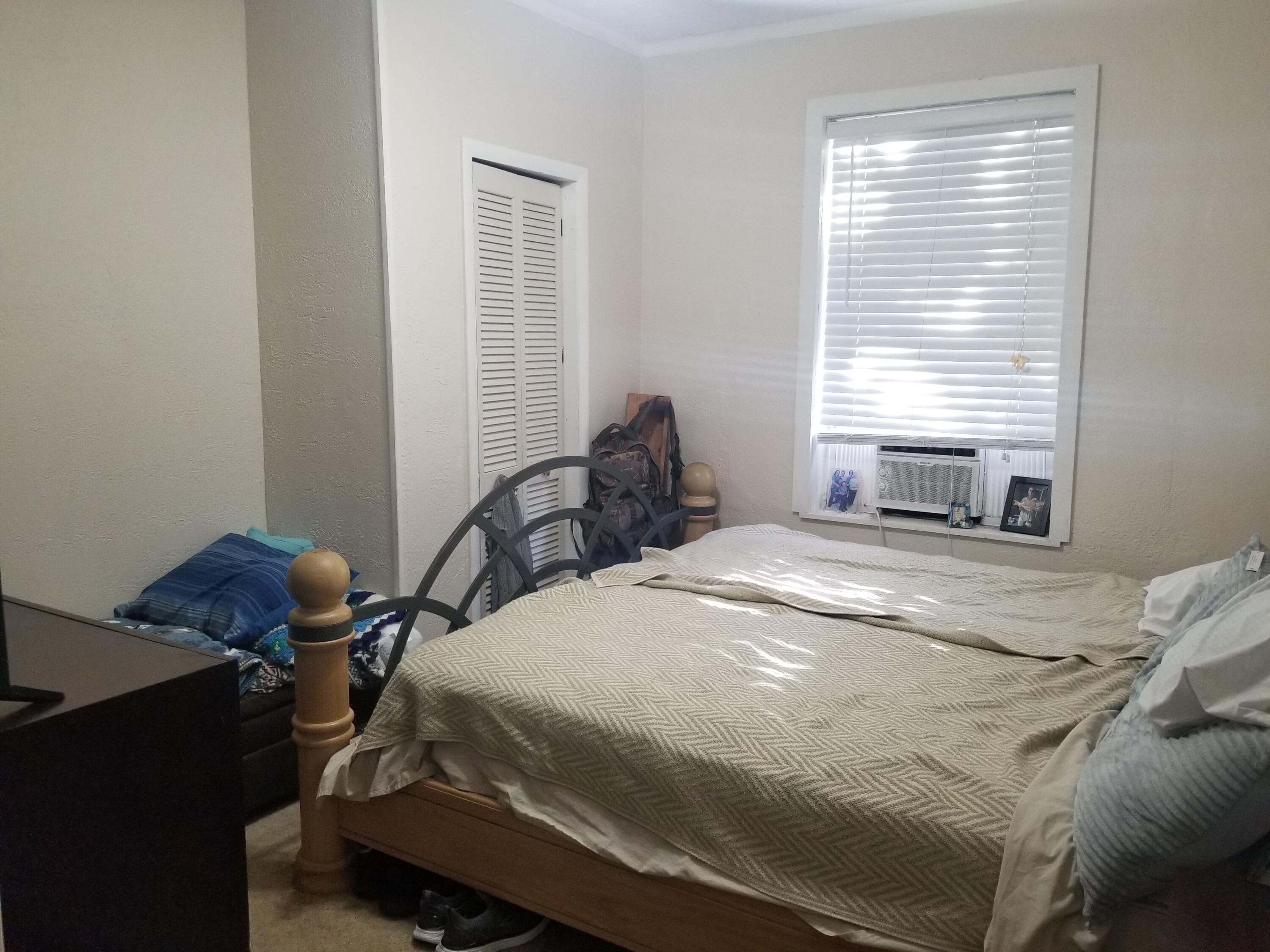 1224 Raymond Avenue Fort Pierce, FL 34950 - Photo 9 of 27 a bedroom with a bed and a window