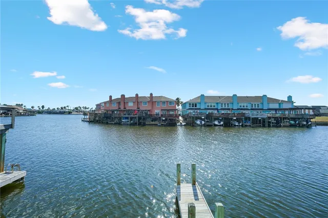 a view of a ocean with boats and large trees