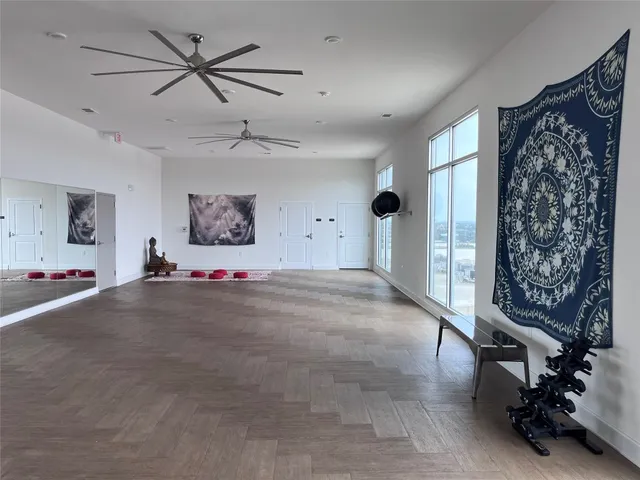 a living room with furniture and a ceiling fan