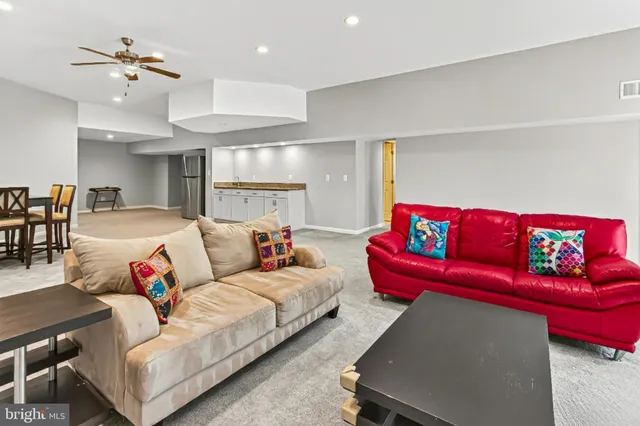 a living room with furniture and kitchen view