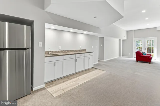 a kitchen with stainless steel appliances granite countertop a refrigerator and a sink