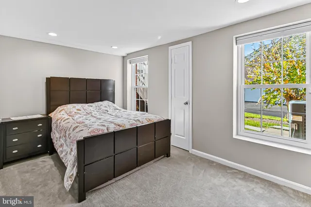 a room with a bed and a dresser