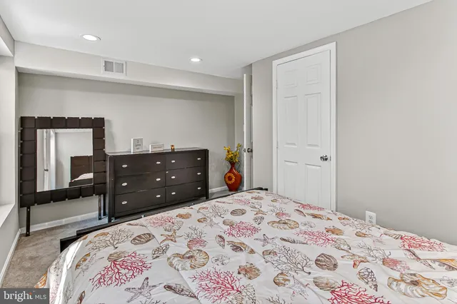 a bedroom with a bed and a dresser