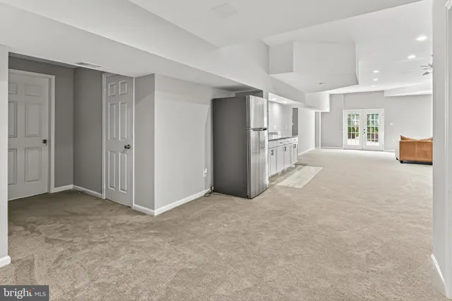 an empty room with windows and closet