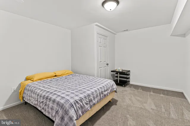 a bedroom with a bed and dresser