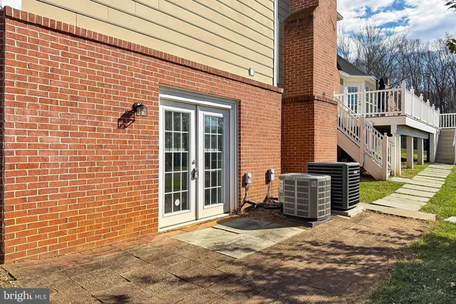 a view of a brick house with a door and wooden walls