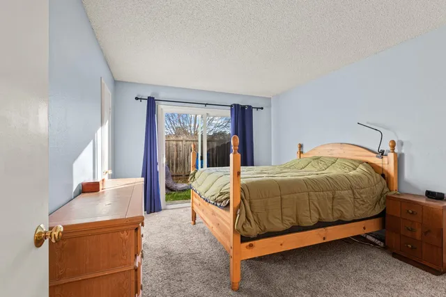 a bed sitting in a bedroom next to a window