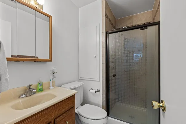 a bathroom with a sink a toilet and shower