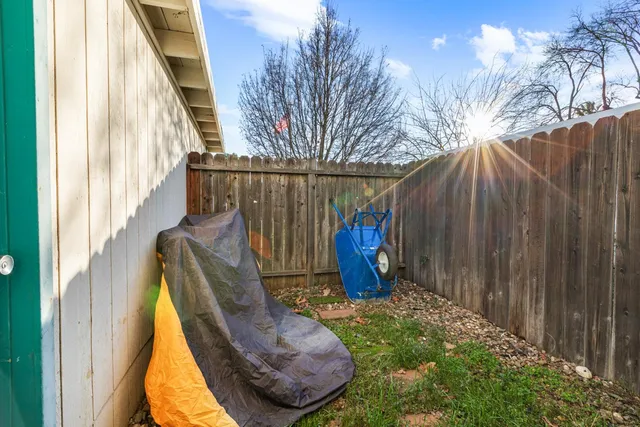 a view of balcony with wooden fence and potted plants