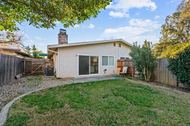 a view of a house with a yard and sitting area