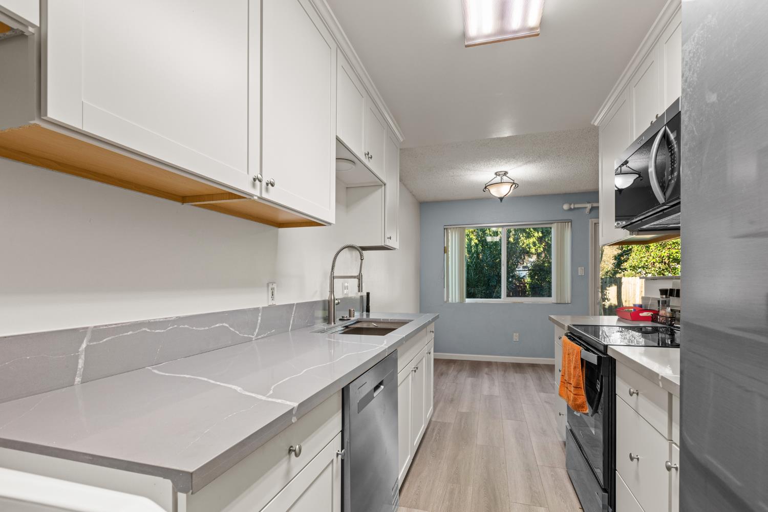 4329 Zephyr Way Sacramento, CA 95821 - Photo 7 of 44 a kitchen with a sink stove and cabinets