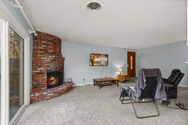 a living room with furniture gym equipment and a fireplace