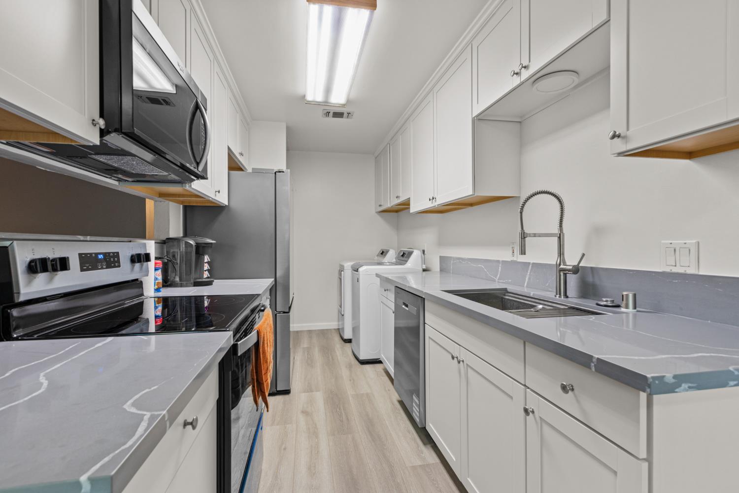 4329 Zephyr Way Sacramento, CA 95821 - Photo 10 of 44 a kitchen with stainless steel appliances granite countertop a sink stove and cabinets