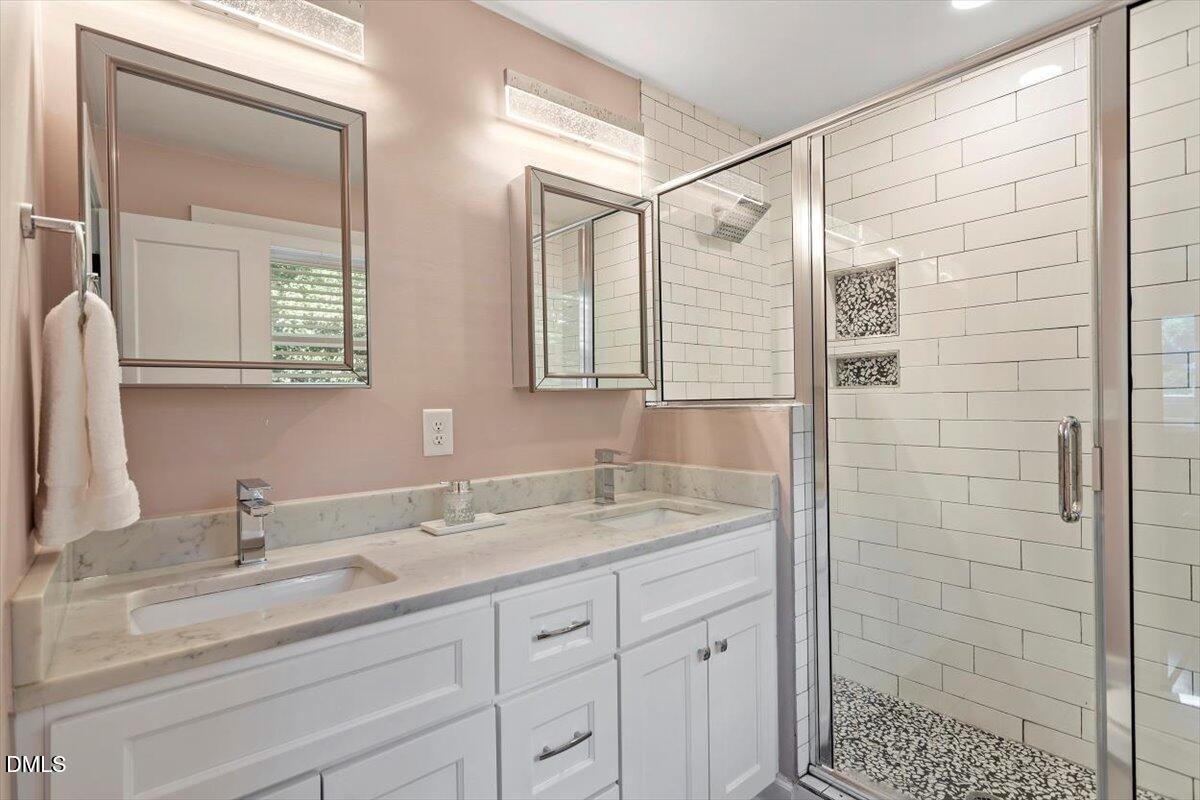 2120 Hillock Drive Raleigh, NC 27612 - Photo 26 of 29 a bathroom with a shower sink and mirror