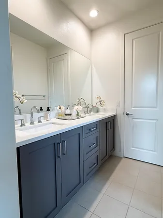 a bathroom with a double vanity sink and mirror