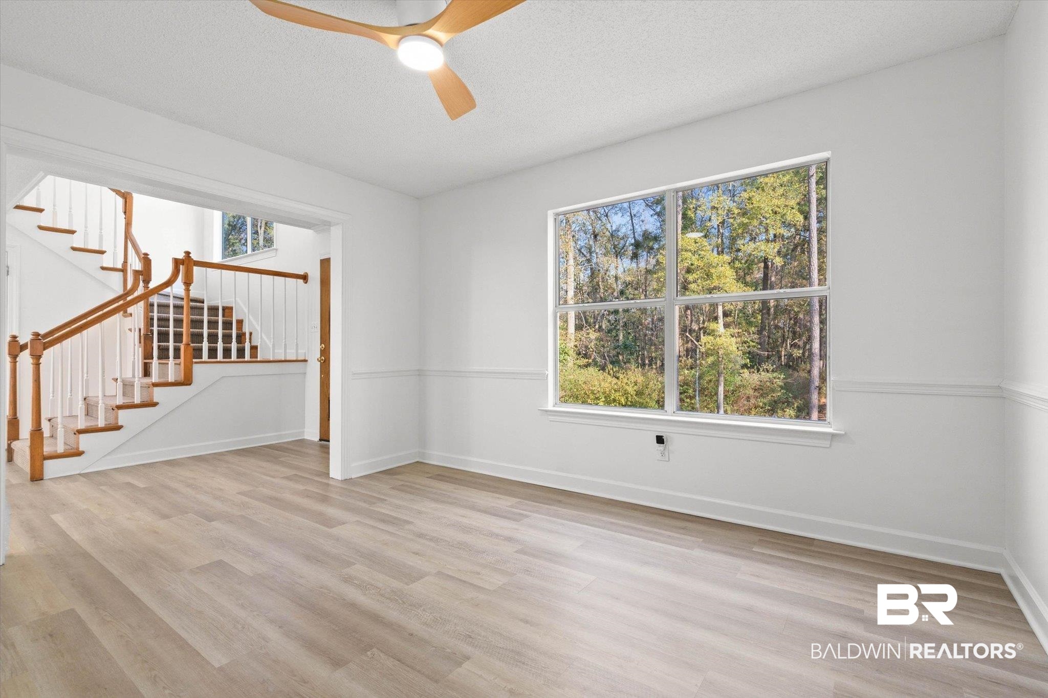 3847 Riviere Du Chien Road Mobile, AL 36693 - Photo 9 of 51 Spare room with ceiling fan, light wood finished floors, and a textured ceiling