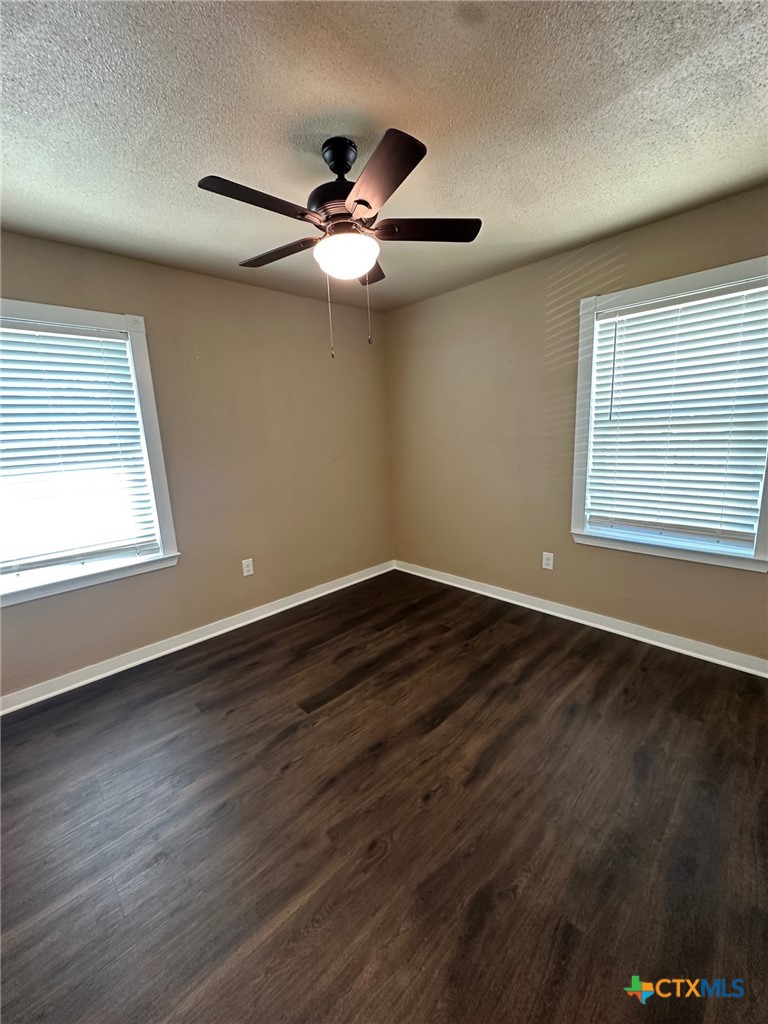 952 Fannin Loop Temple, TX 76501 - Photo 4 of 15 an empty room with wooden floor fan and windows