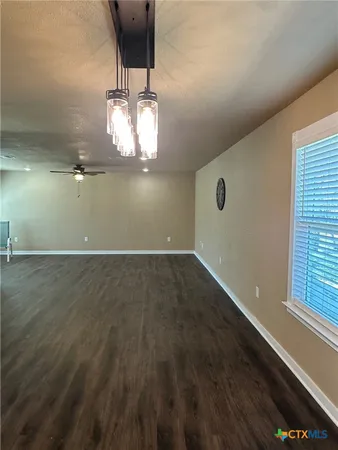 a kitchen with a refrigerator a stove and white cabinets