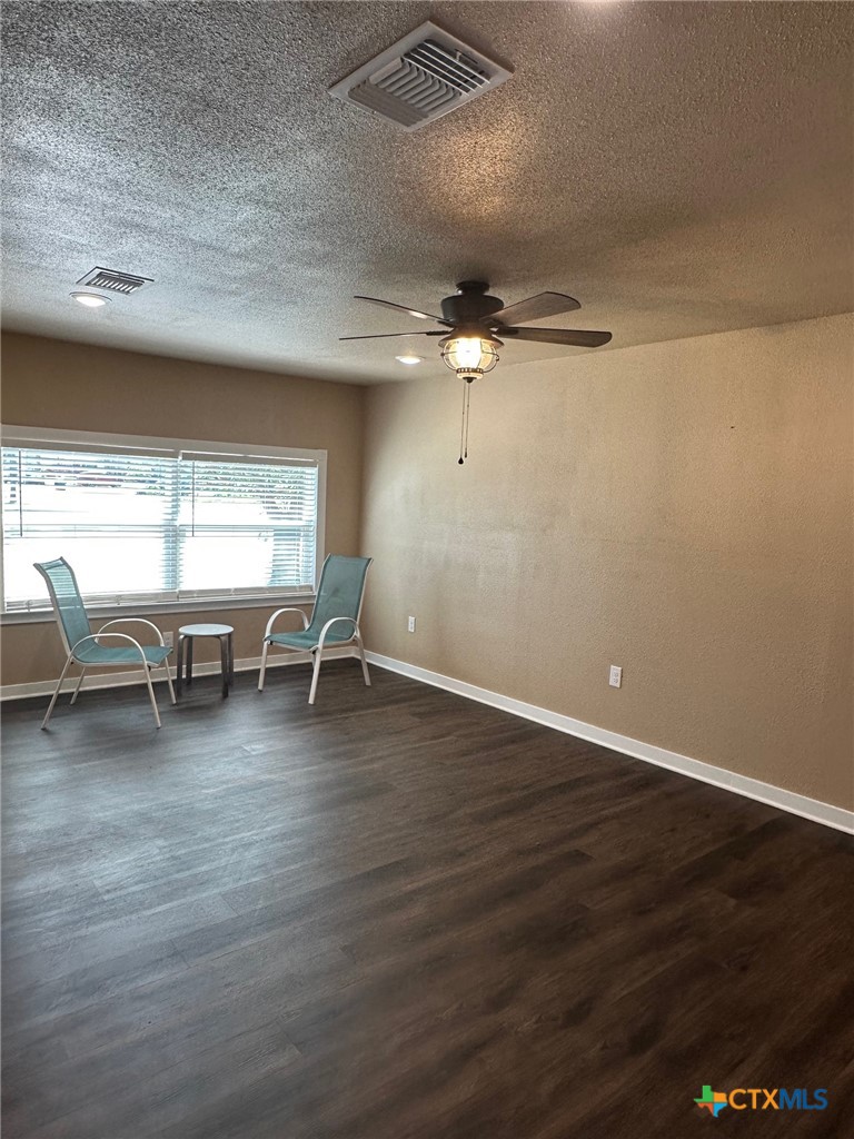 952 Fannin Loop Temple, TX 76501 - Photo 8 of 15 a view of a livingroom with wooden floor a ceiling fan and windows