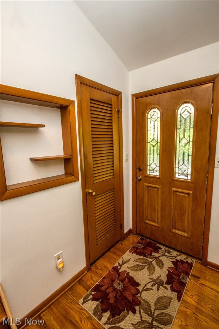 8107 Stone Road Independence, OH 44131 - Photo 2 of 29 Foyer with vaulted ceiling and hardwood floor