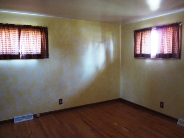 4718 Highcrest Road Rockford, IL 61107 - Photo 11 of 20 an empty room with wooden floor and windows