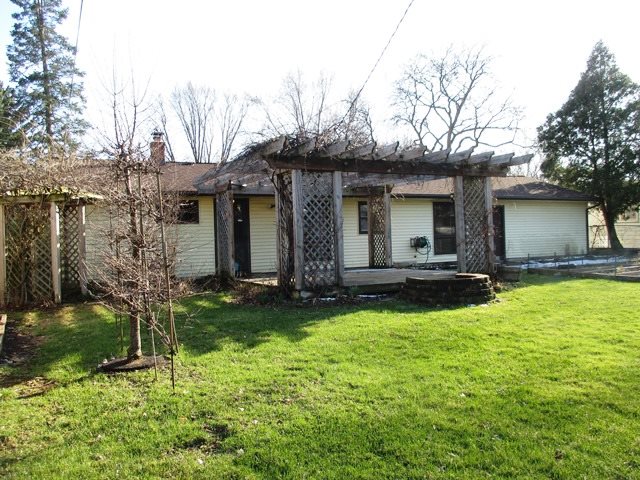 4718 Highcrest Road Rockford, IL 61107 - Photo 17 of 20 a view of a house with backyard and a tree