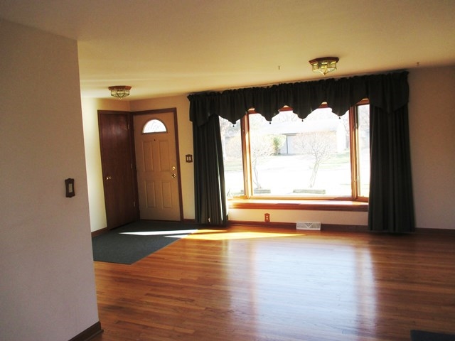 4718 Highcrest Road Rockford, IL 61107 - Photo 3 of 20 a view of a room with wooden floor and a window