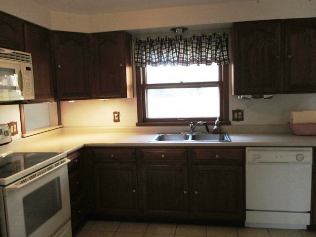 4718 Highcrest Road Rockford, IL 61107 - Photo 7 of 20 a kitchen with a sink window and cabinets