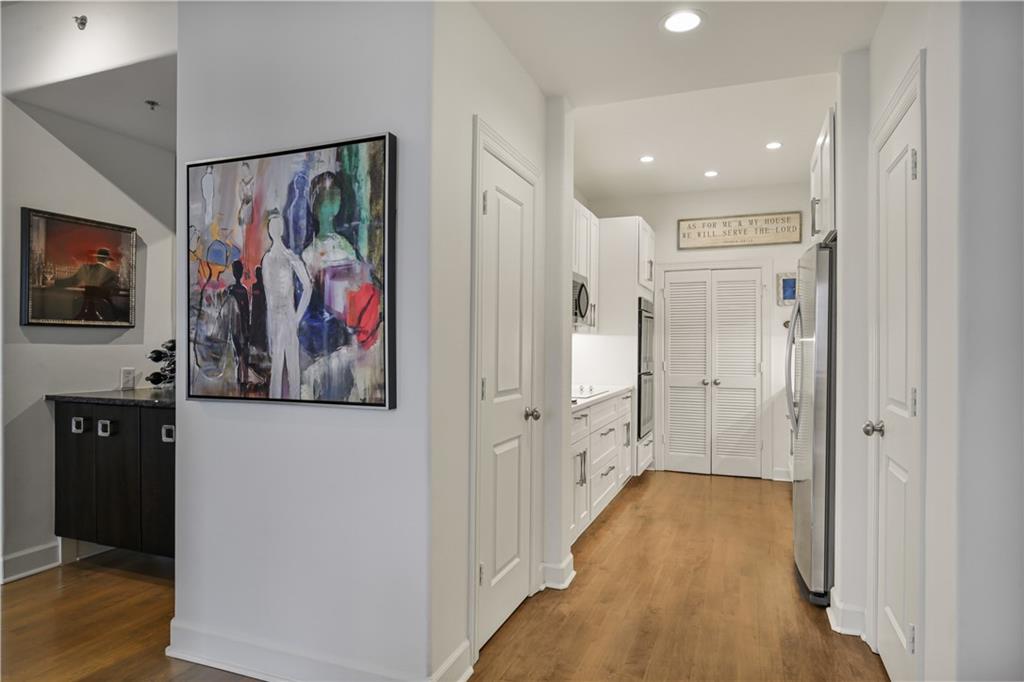 3445 Stratford Road Northeast, Unit 3703 Atlanta, GA 30326 - Photo 13 of 59 a view of a hallway with wooden floor and furniture